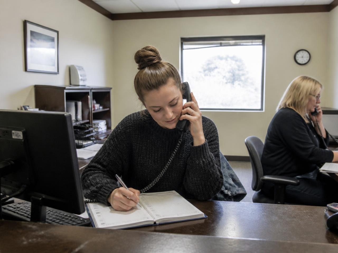 Small business team handling incoming calls and booking requests